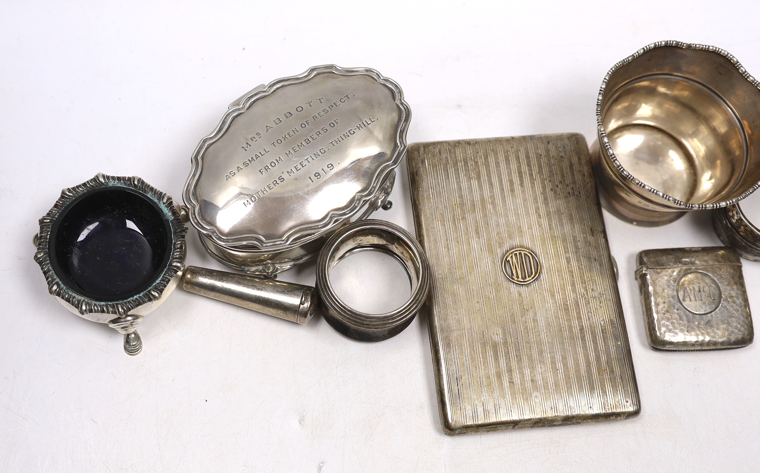 Sundry small silver including an Asprey silver cigarette case, 12.7cm, napkin ring, trinket box, pair of salts, vesta, small vase and a cheroot holder case, together with a plated napkin ring.